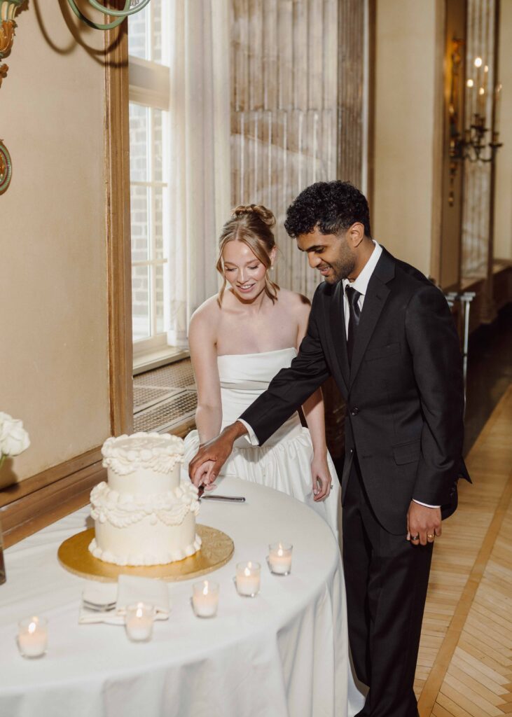 bride and groom cutting cake at Hotel Syracuse wedding Grand ballroom