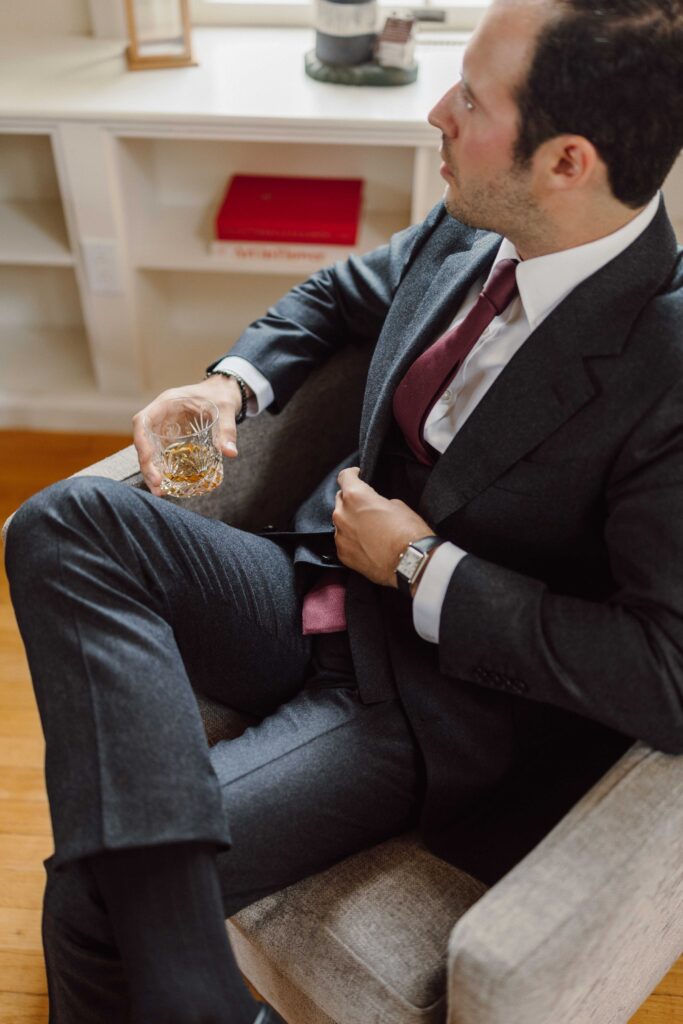 groom sipping whiskey for a Finger Lakes Wedding