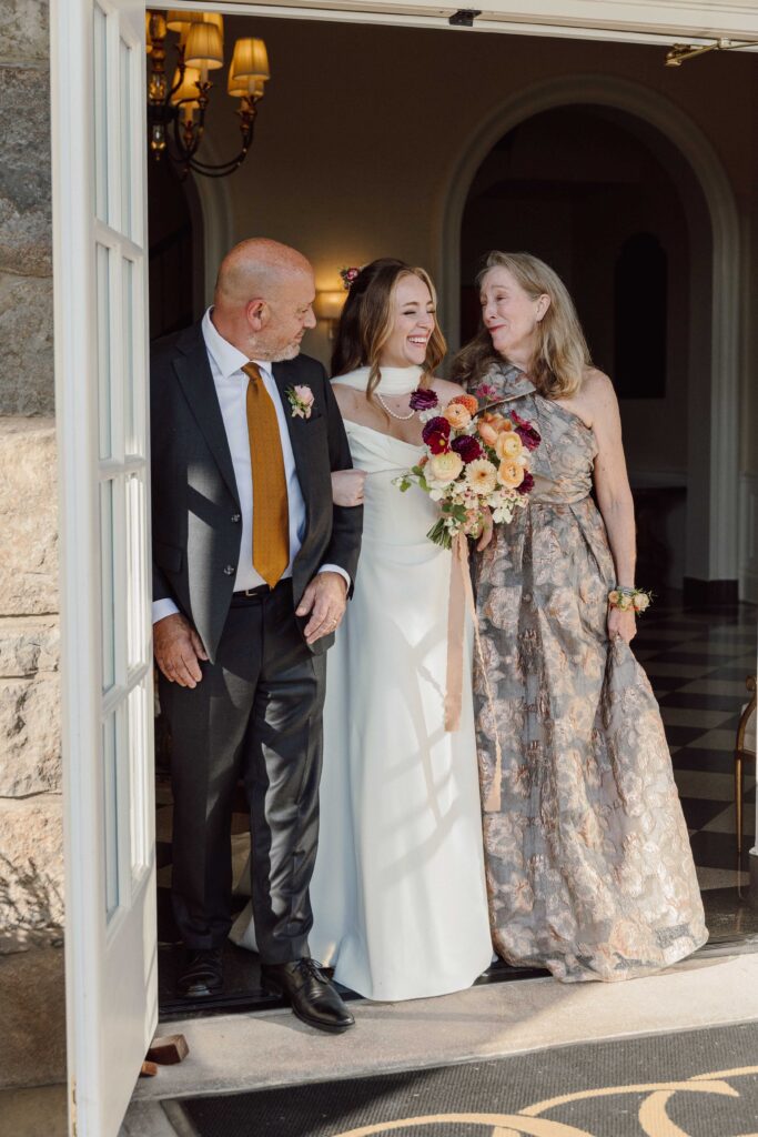 bride and her parents walking down the aisle