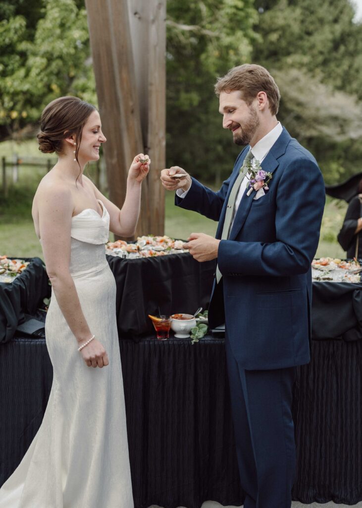 bride and groom eating oysters