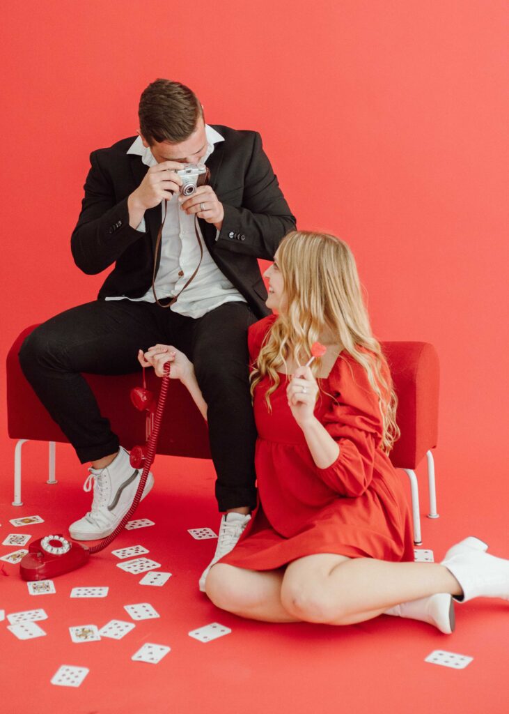 red backdrop valentine's day couple photos