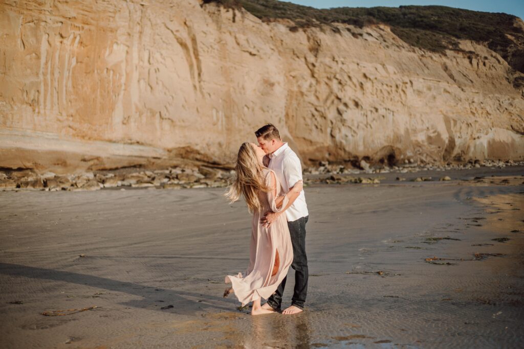 couple kissing on Torrey Pines beach, San Diego CA