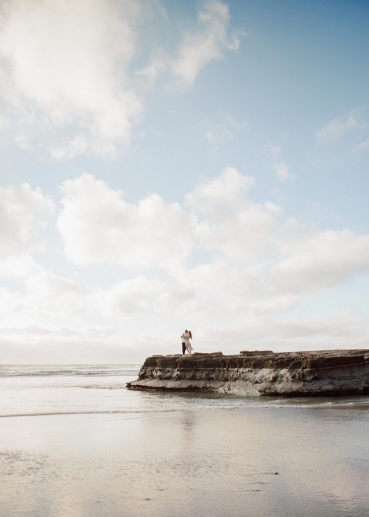 wide angle photo of couple on Torrey Pines beach, San Diego CA